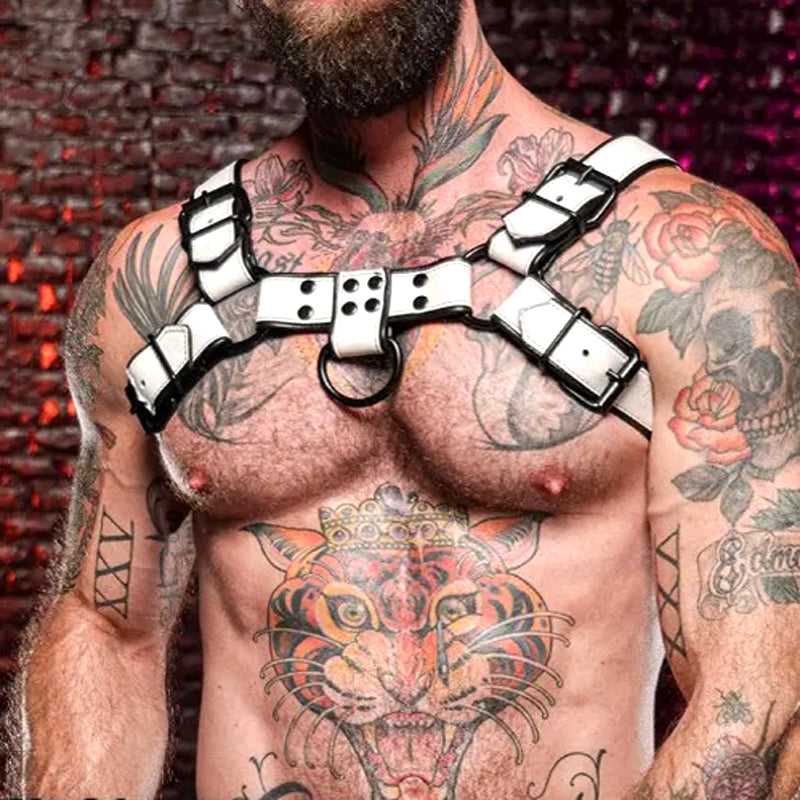 Men's white thickened and black contrasting leather harness with adjustable straps and metal rings, worn over tattoos on a muscular chest