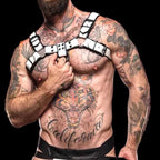 Tattooed man with a large tiger and California script tattoo on his chest, wearing a white thickened and black contrasting men's harness