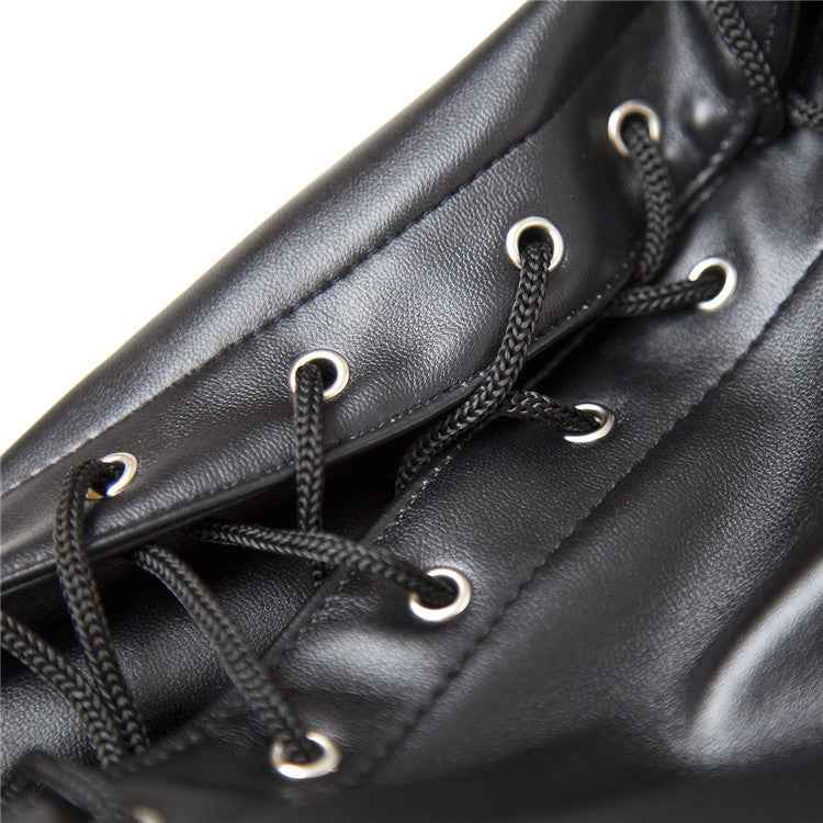 Close-up of black leather material with metal eyelets and laces, showing detailed craftsmanship of fetish hood mask.