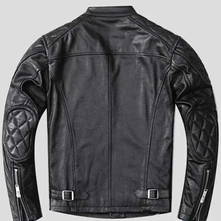 Black quilted leather motorcycle jacket with textured quilted panels on sleeves, zippered cuffs, and adjustable waist buckles, designed for biker style.