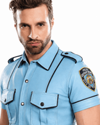 Male police officer in light blue faux leather uniform with shoulder patches, standing at nightclub entrance, back view