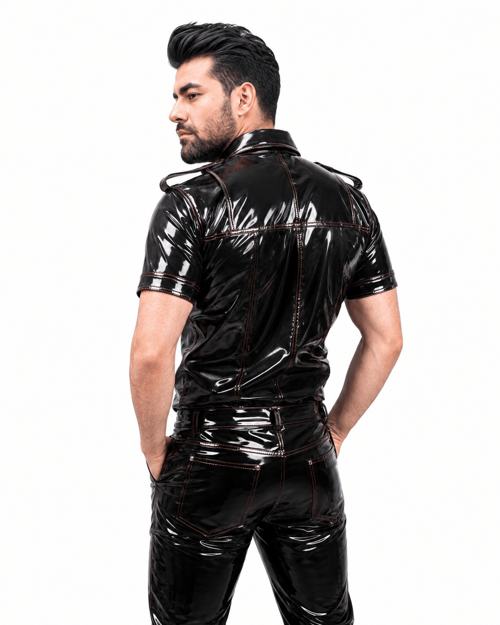 Side profile of a male model wearing a black PVC fetish shirt with shiny finish, detailed collar, and shoulder epaulets, against a white background.