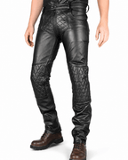 Close-up of black leather pants with quilted knee and thigh panels, featuring a front zipper and belt, designed for motorcycle riding.