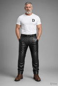 Men's padded thru zip black leather pants with quilted knee panels, front zipper, and belt loops, styled with brown boots, ideal for biker fashion.