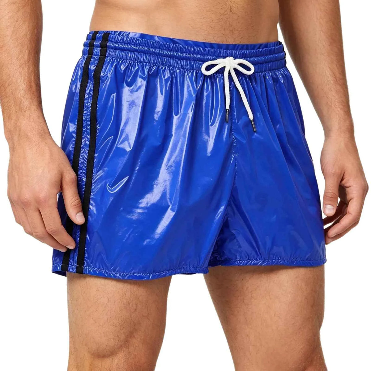 Close-up of man’s waist in shiny blue PVC shorts with white drawstring, showing elastic waistband and side black stripe, gray background